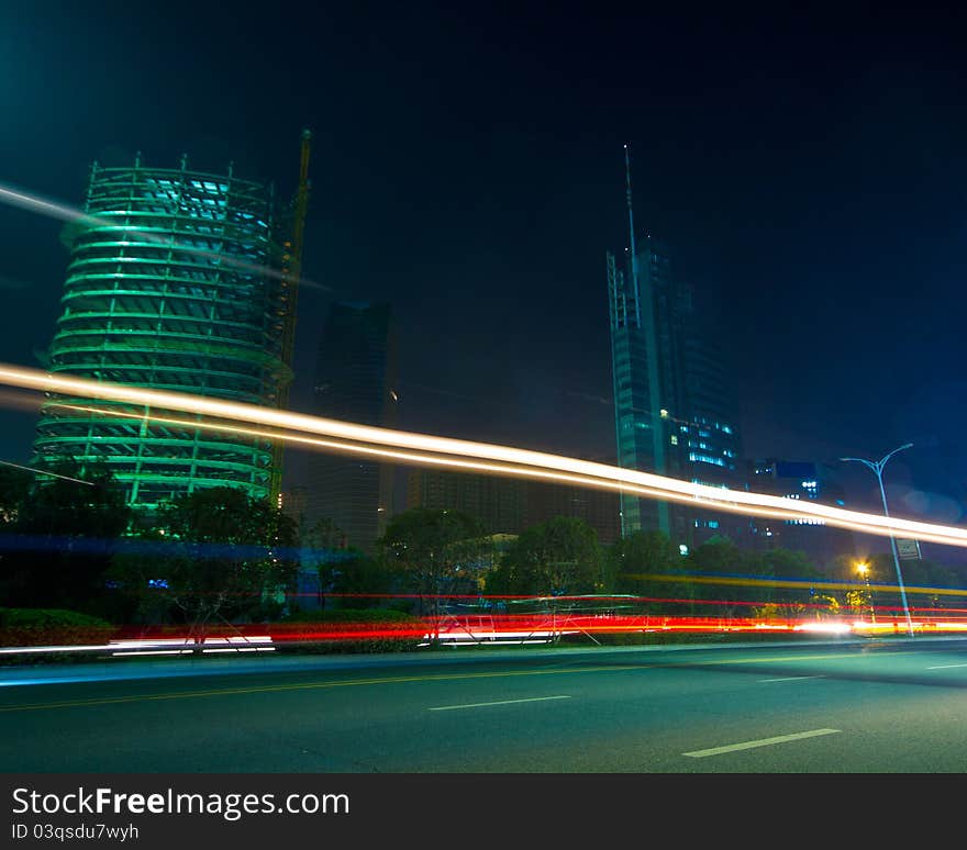 The light trails on the modern building background in shanghai china.