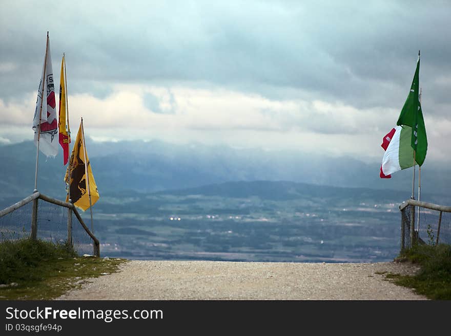 An old road from Switzerland to France with flags. An old road from Switzerland to France with flags