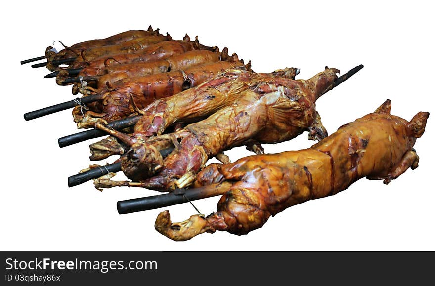 Whole Pig and Lamb Being Roasted - isolated on a white background.