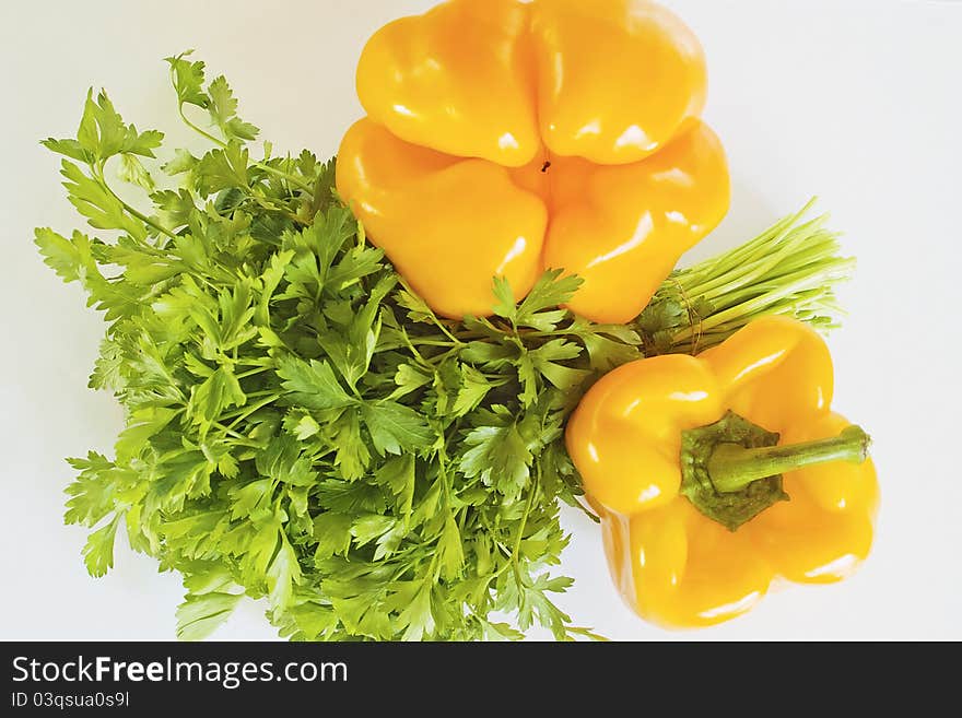 Yellow pepper and parsley on a white background