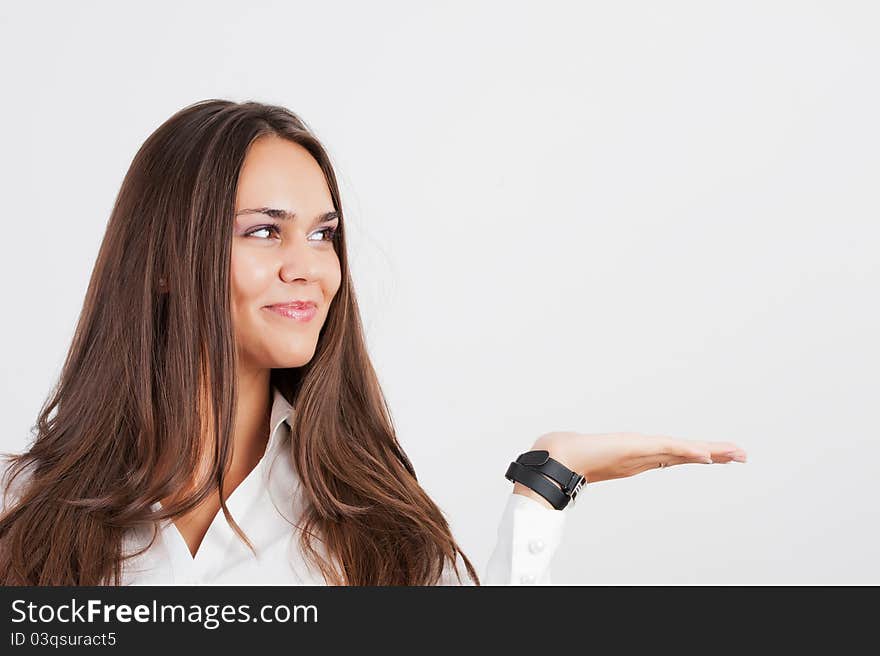 Beautiful woman showing something on the palm of her hand