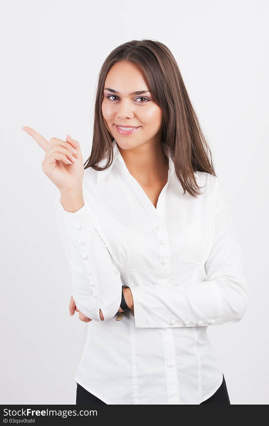 Happy smiling young business woman showing blank area for sign or copyspase, isolated on white background