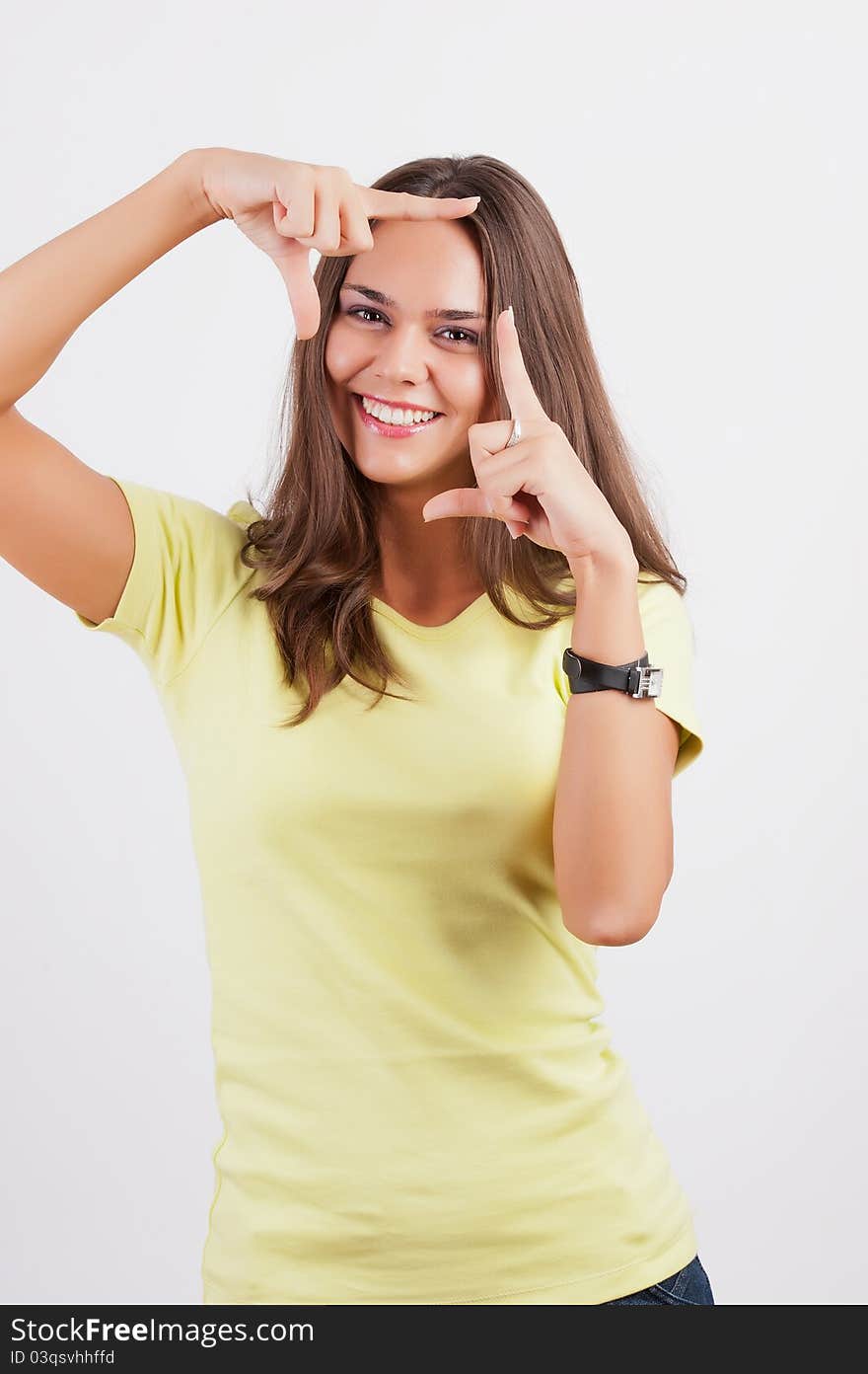 Portrait of young happy smiling business woman framing her face with hands, isolated on white background