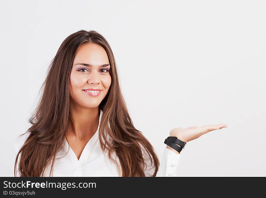 Smiling woman showing copy space for product with open hand palm - smiling friendly expression, Isolated on white background