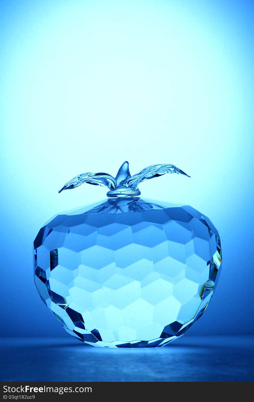 Crystal apple on blue background