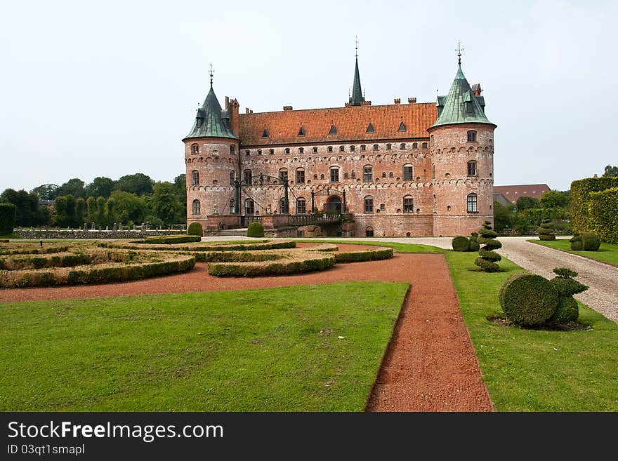 Egeskov castle slot landmark fairy tale castle in Funen Denmark view from the back garden. Egeskov castle slot landmark fairy tale castle in Funen Denmark view from the back garden