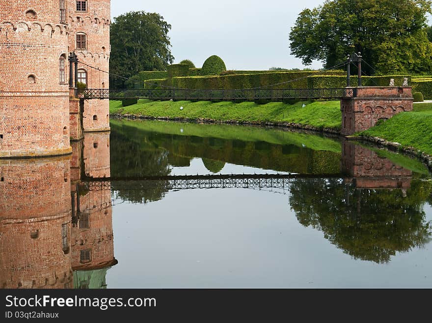 Egeskov castle slot landmark fairy tale castle in Funen Denmark view from the back bridge. Egeskov castle slot landmark fairy tale castle in Funen Denmark view from the back bridge