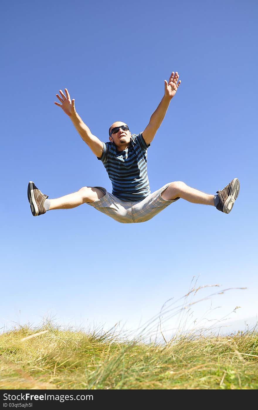 Happy young male jumping in the air