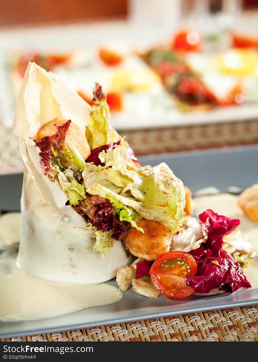 Salad with Fried Salmon in Dough with Lemon-Cream Sauce and Cherry Tomato. Salad with Fried Salmon in Dough with Lemon-Cream Sauce and Cherry Tomato