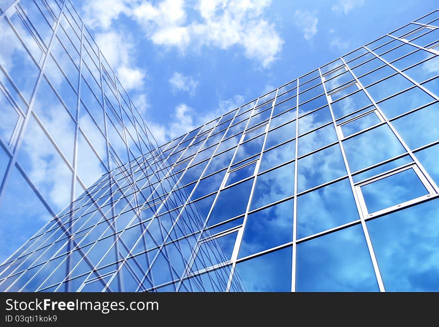 High-rise glass building with sky and clouds reflection. High-rise glass building with sky and clouds reflection