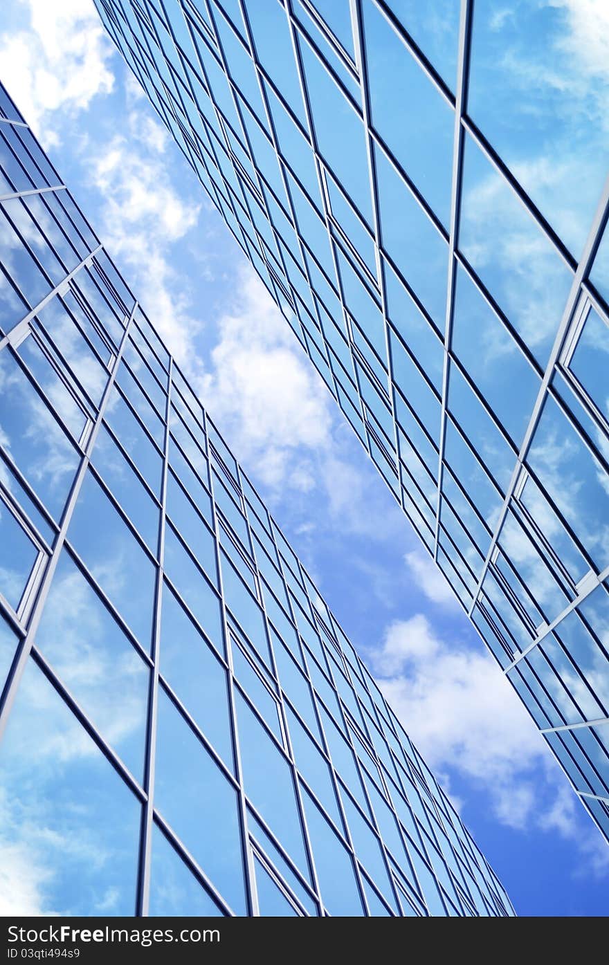 High-rise glass building with sky and clouds reflection. High-rise glass building with sky and clouds reflection