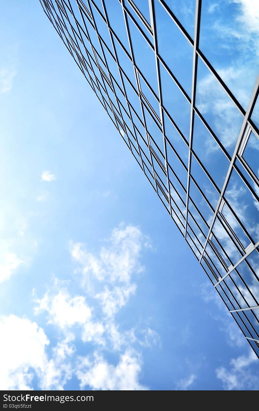 High-rise glass building with sky and clouds reflection. High-rise glass building with sky and clouds reflection