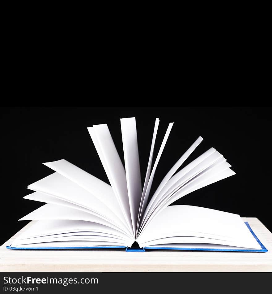 Open book on a black background for cutout