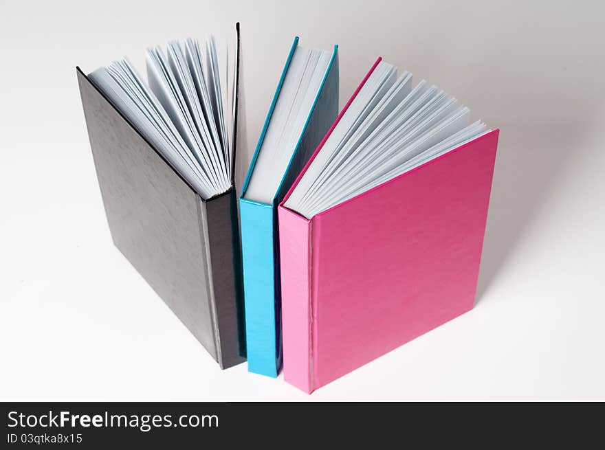 Three books for education on a white table. Three books for education on a white table