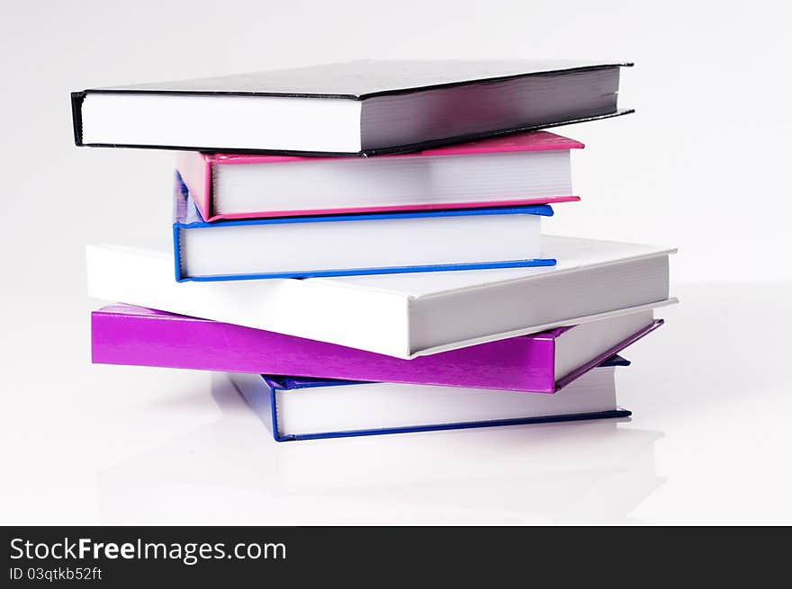 Six education school books on a white table