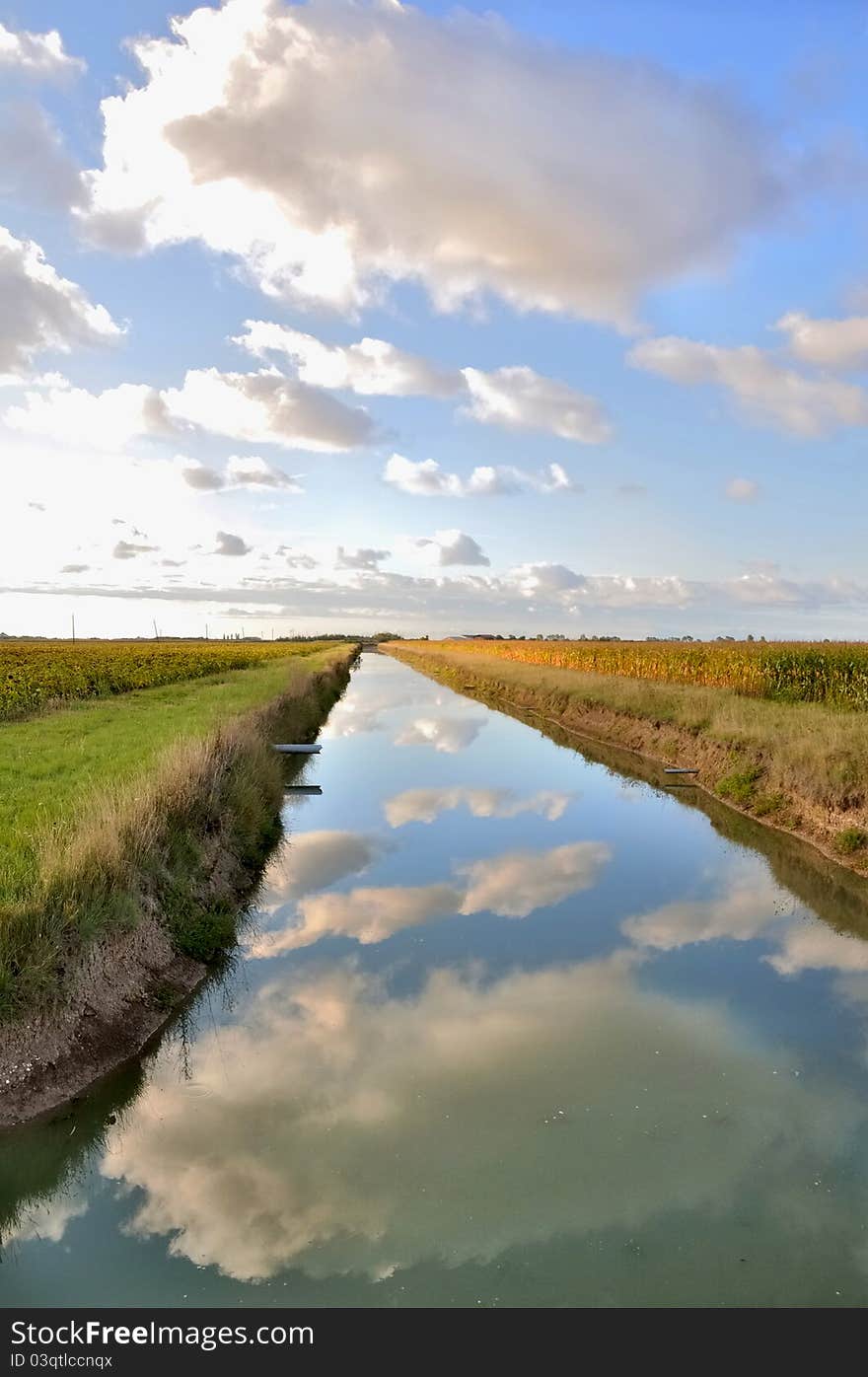 Reflection Of Clouds In The Water Of A Canal