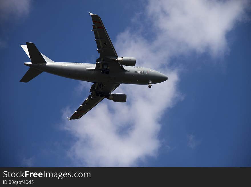 A grey german airplain on the blue sky. A grey german airplain on the blue sky