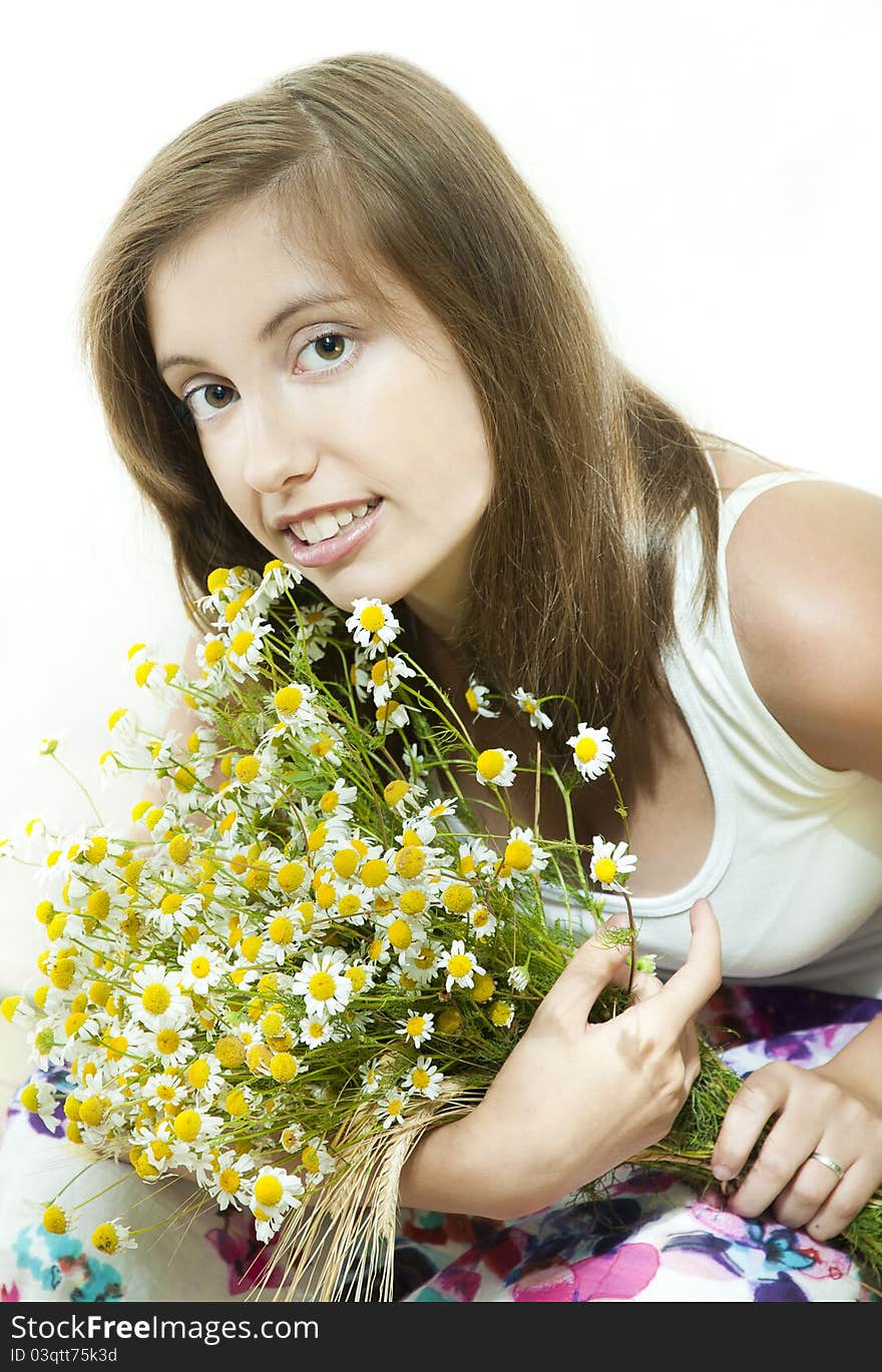 Young  smiling girl with bouquet of camomile against white background. Young  smiling girl with bouquet of camomile against white background