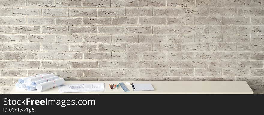 Modern office interior. Brick wall with details on the desk