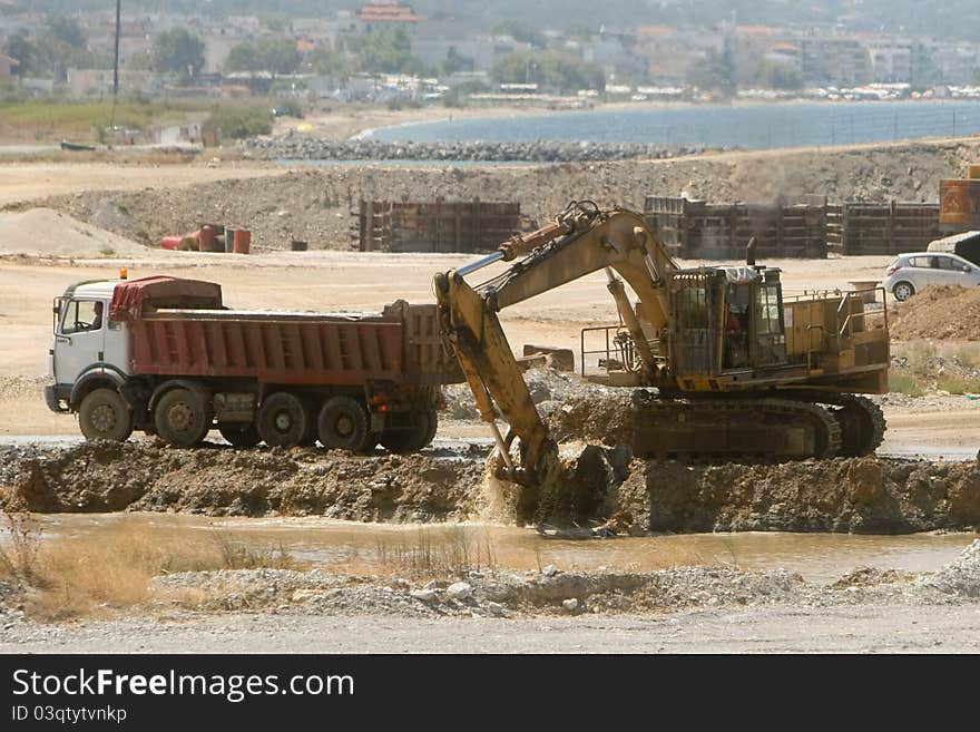 Bulldozer loading a truck