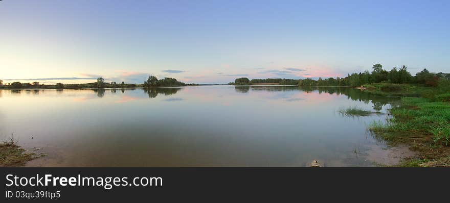 Summer panoramic landscape with beautiful lake at sunset. Ruzskoe lake in Russia. Summer panoramic landscape with beautiful lake at sunset. Ruzskoe lake in Russia