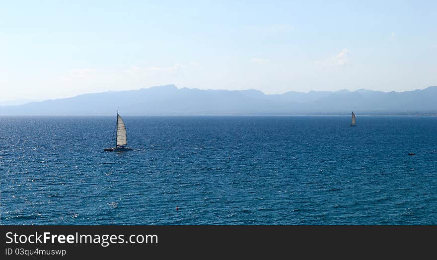 Sailboat in regatta on blue sea. Panorama