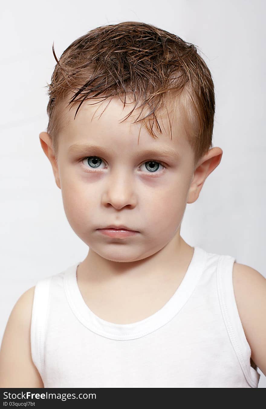 The pensive caucasian boy with wet hair