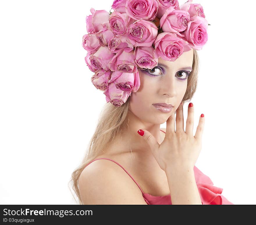 Young beautiful woman with pink flowers on her head over white