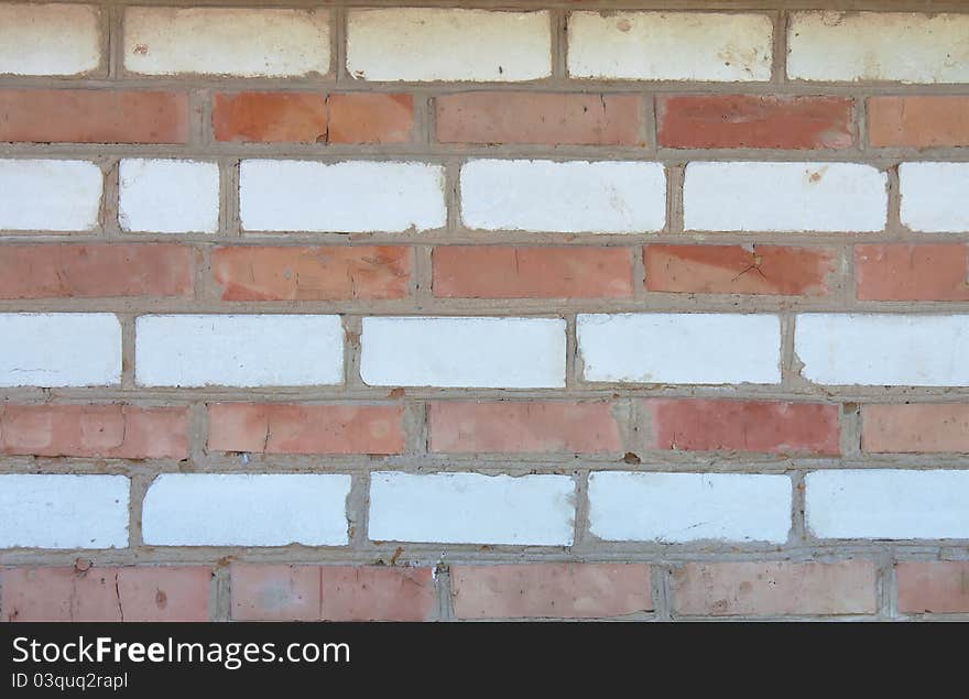 Old red and white striped brick wall, texture. Old red and white striped brick wall, texture