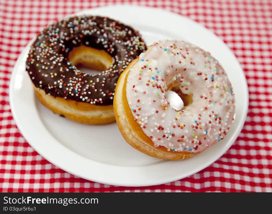 A couple of donuts on table.