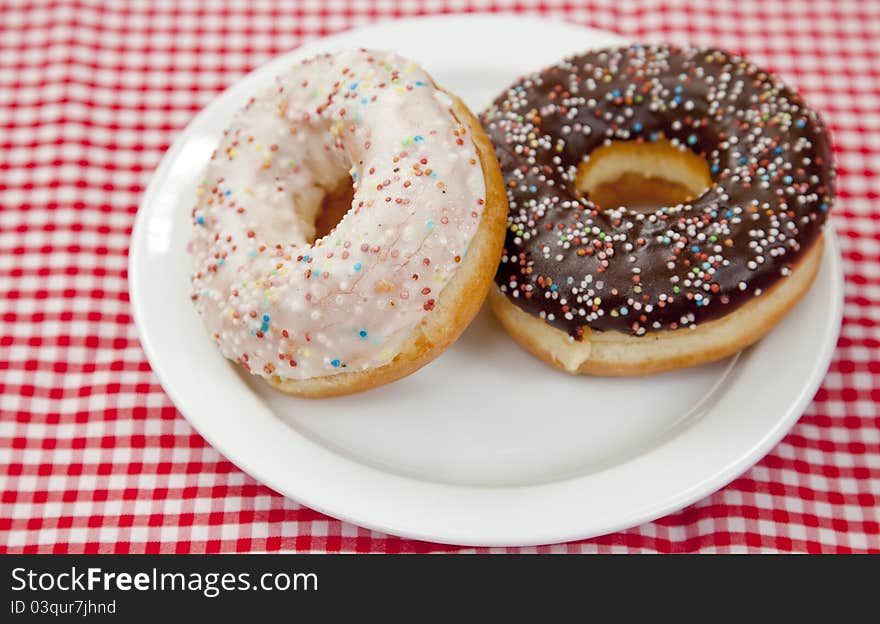 A couple of donuts on table.