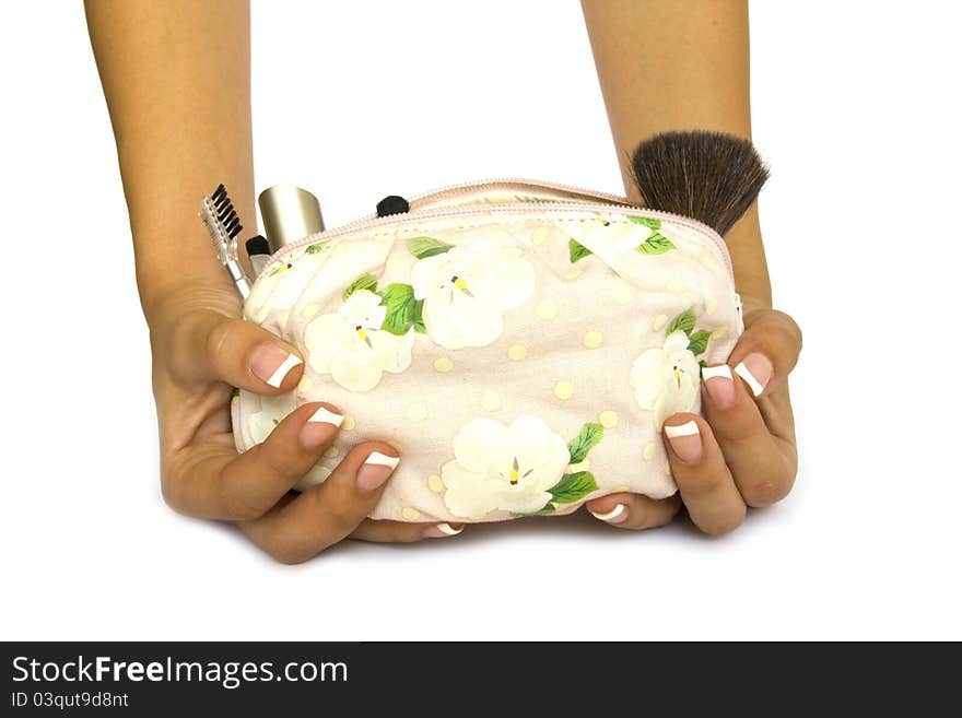 Bag of cosmetics in female hands on a white background. Bag of cosmetics in female hands on a white background