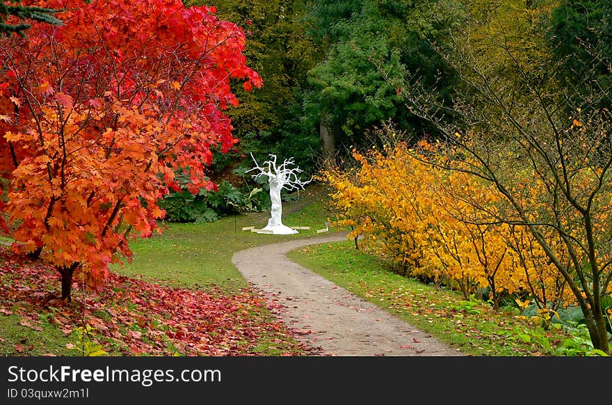 The white tree sculpture in the autumn backdrop