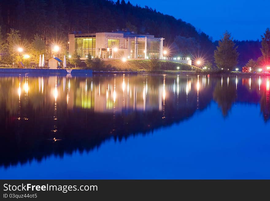 Reflection of lights and light the building in the night lake. Reflection of lights and light the building in the night lake