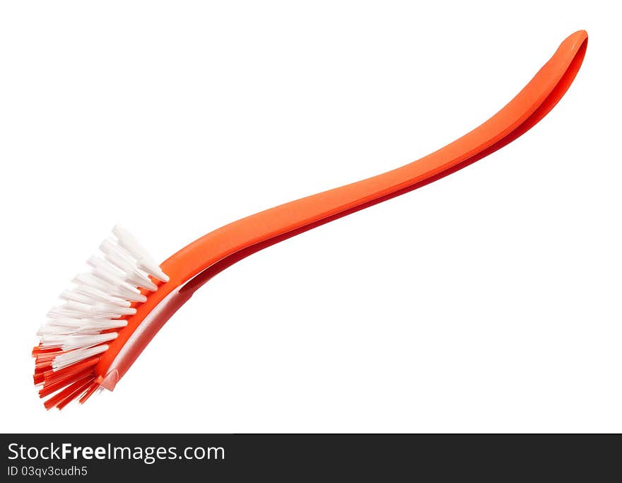 Plastic orange brush for washing dishes on a white background