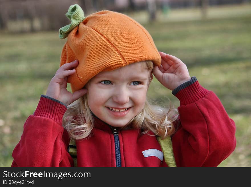 Little Girl Adjusts His Hat During