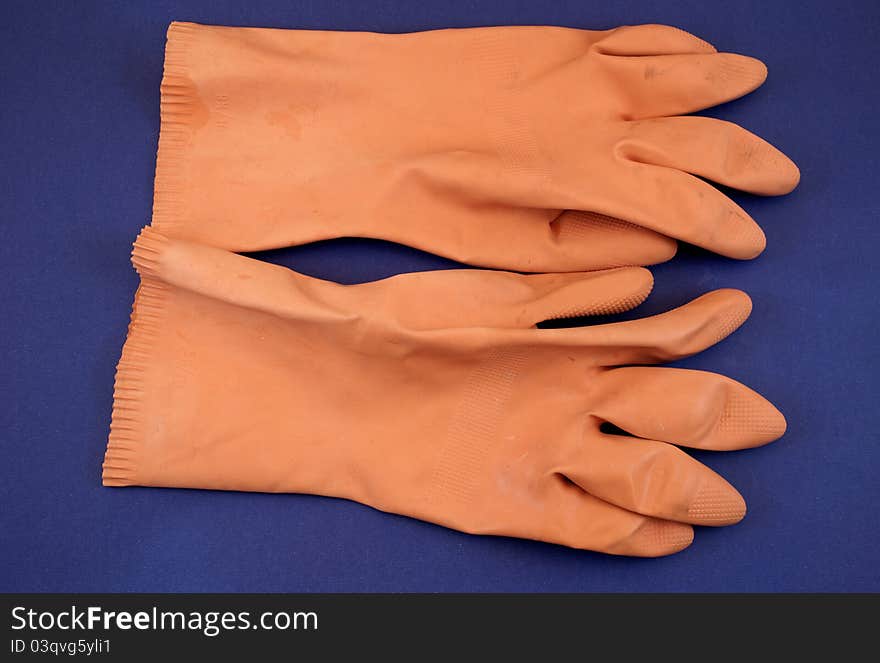 Orange rubber gloves in studio photography