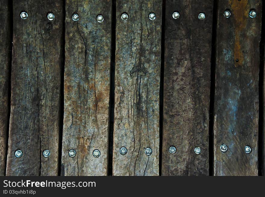 Old wooden boards with stainless steel bolts in