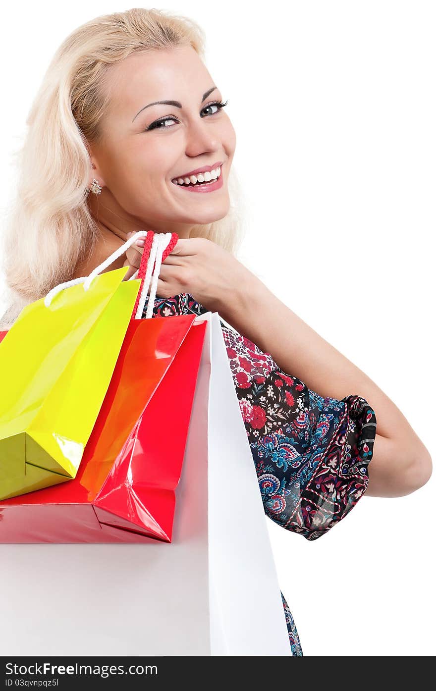 Portrait of a young woman holding a shopping bags over white background. Portrait of a young woman holding a shopping bags over white background