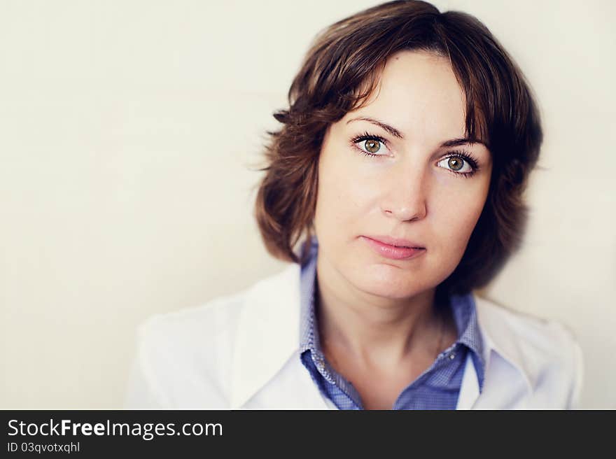 Portrait of a female doctor against a white wall