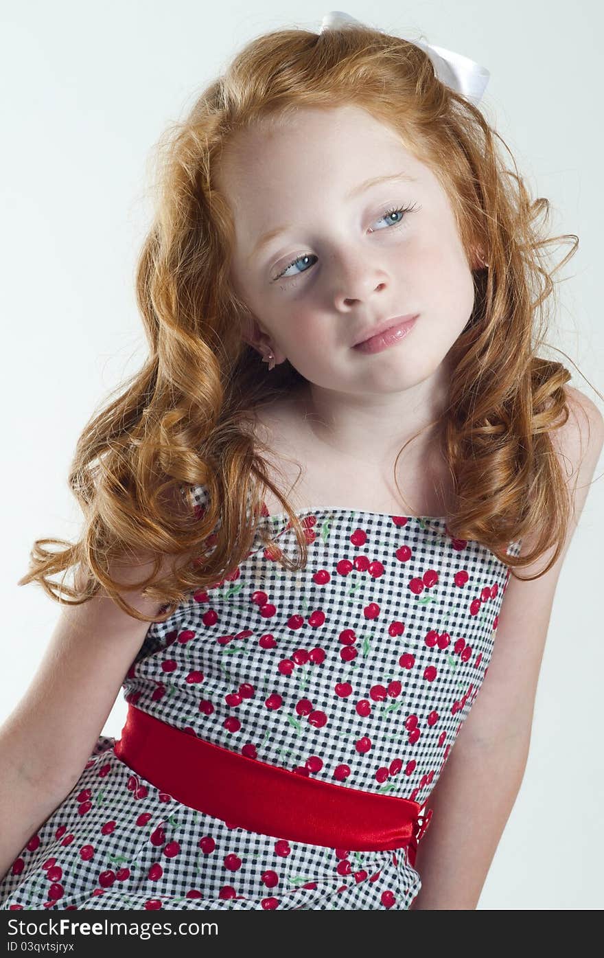 Cute little girl with red hair thinking. Cute little girl with red hair thinking