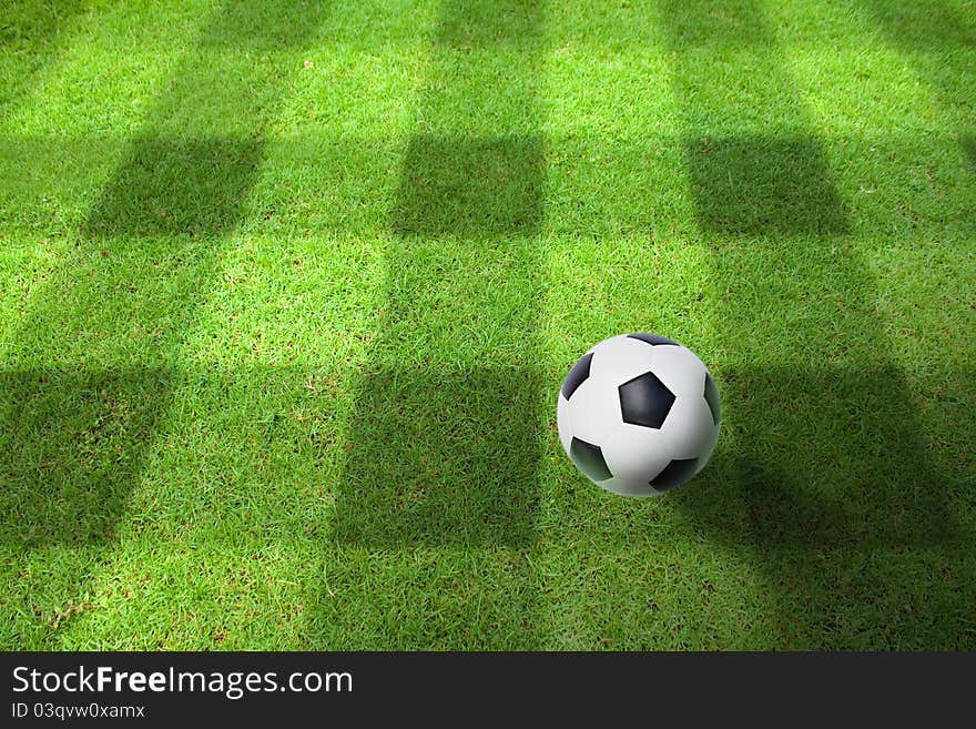 A ball on the green grass of football field. A ball on the green grass of football field