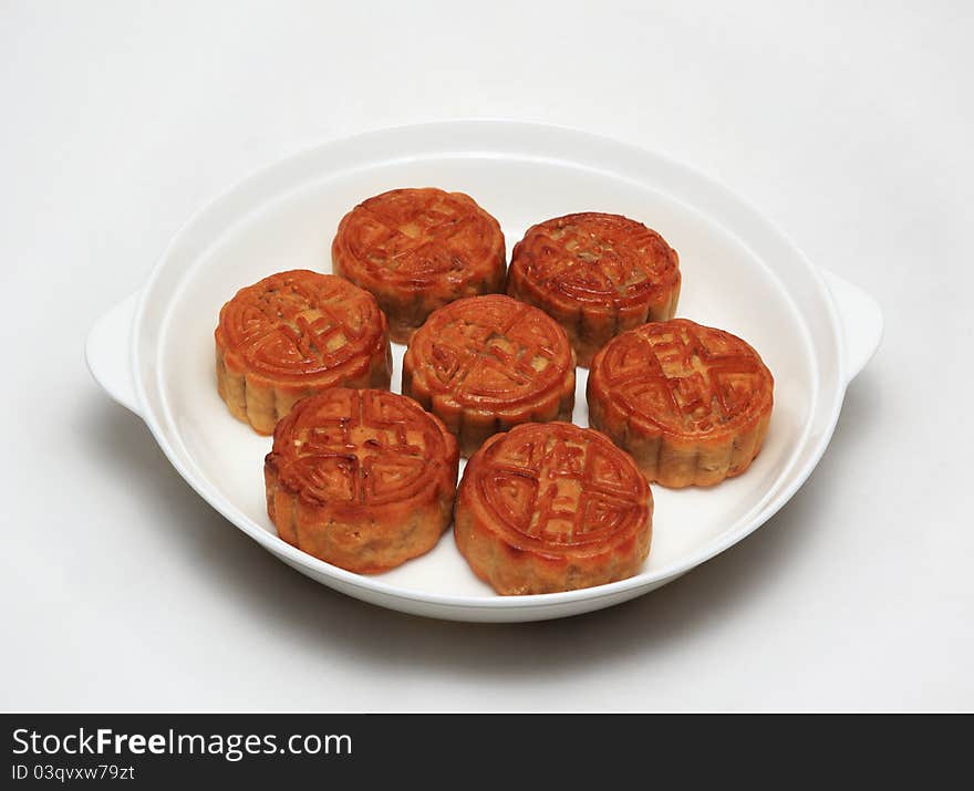 In the white disk on a white background and pastries. In the white disk on a white background and pastries