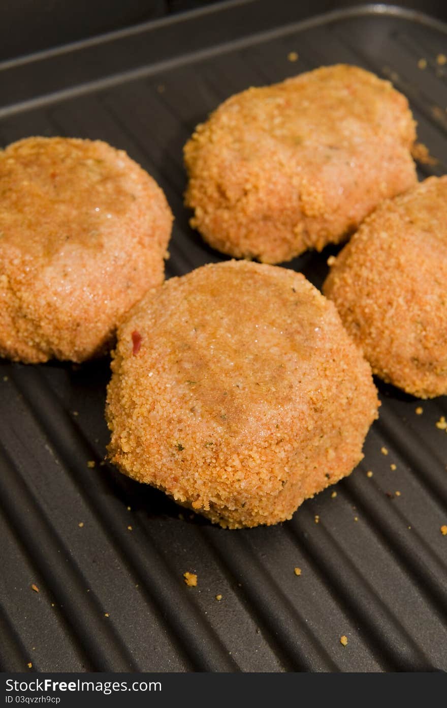 Rrissoles being cooked on a electri grill