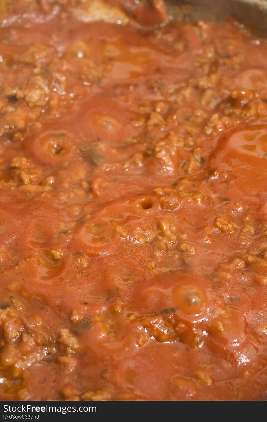 Pasta sauce simmering in a frypan on the stove