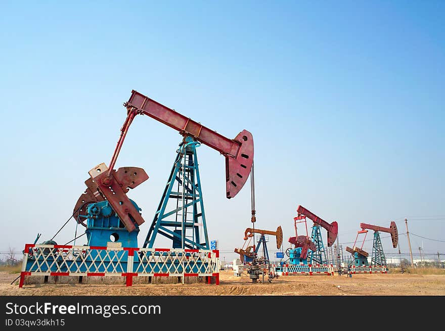 Pump jack group under blue sky. Pump jack group under blue sky