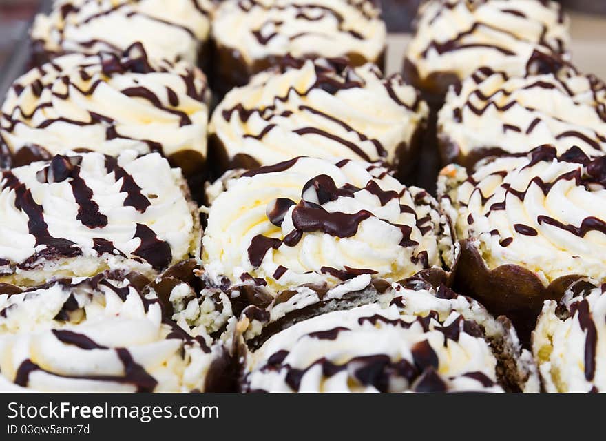 Delicious cupcake topped with butter cream and chocolate. Delicious cupcake topped with butter cream and chocolate