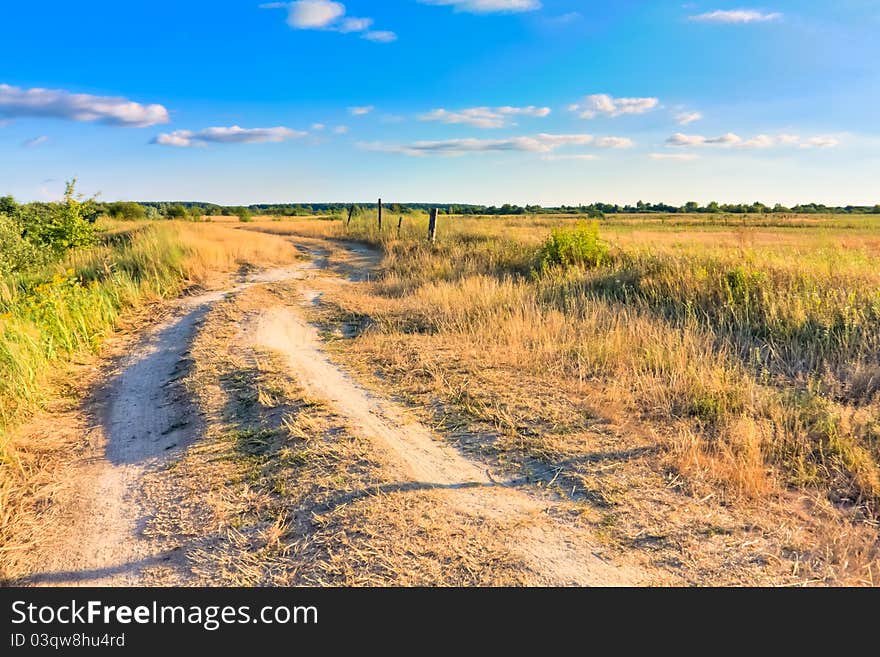 With mountains, pastures, and footpath. With mountains, pastures, and footpath