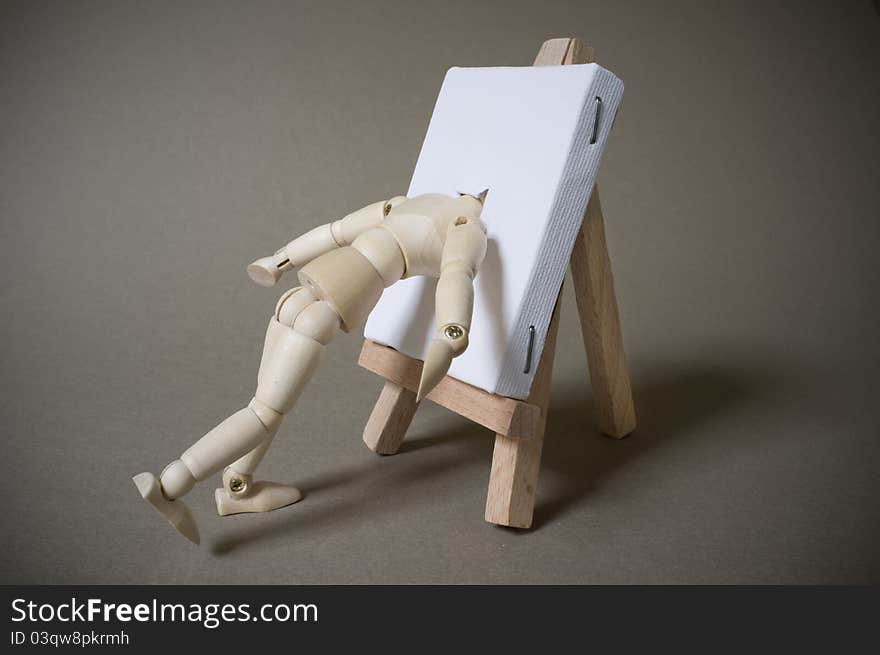 An artists mannequin with head pushed into canvas. An artists mannequin with head pushed into canvas.