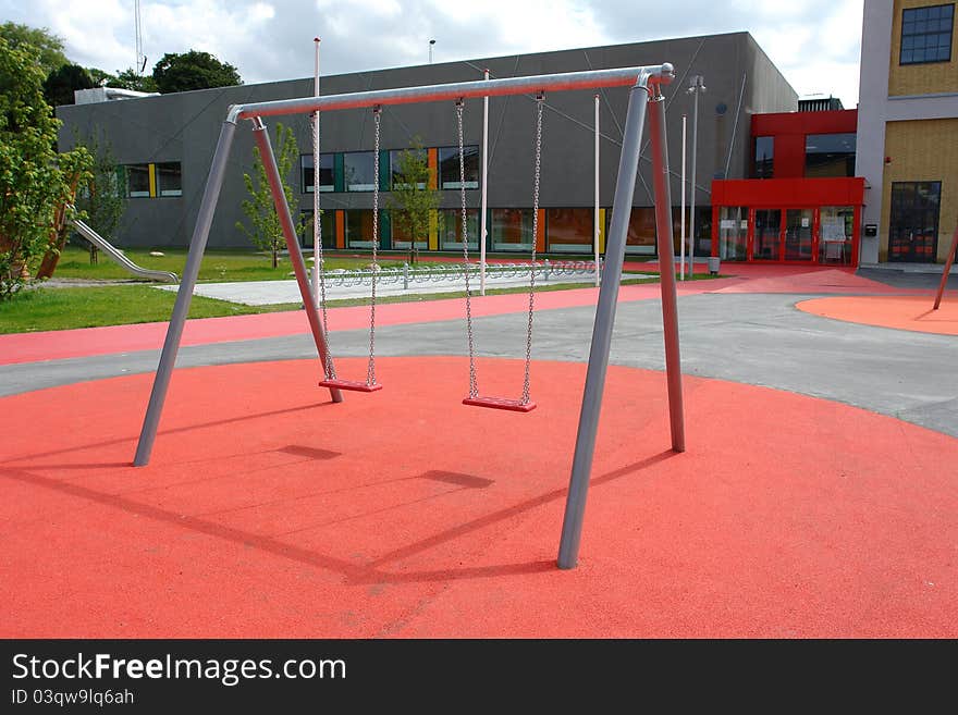 Modern design metal swing in a new city playground. Modern design metal swing in a new city playground